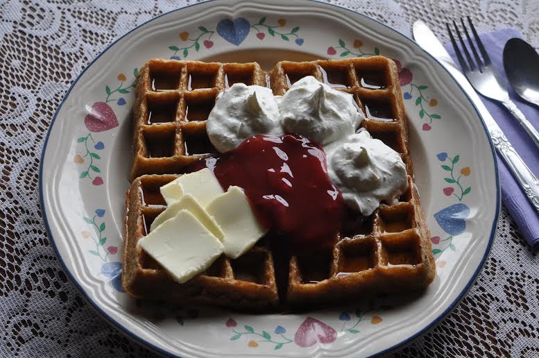 These waffles have a little bit of everything on them: fruit, whipped cream and some butter and , wow, toasted to golden perfection!