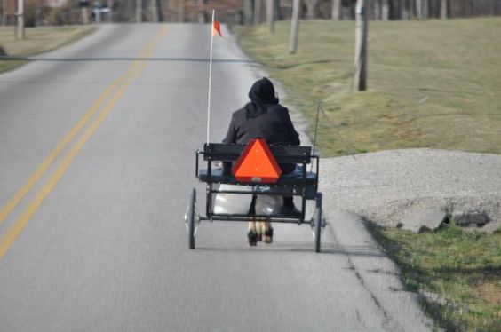 An Amish woman clatters down the road in her buggy in Adams County, Ohio. 