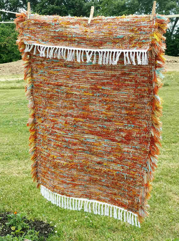 An Amish made orange "rag rug".....