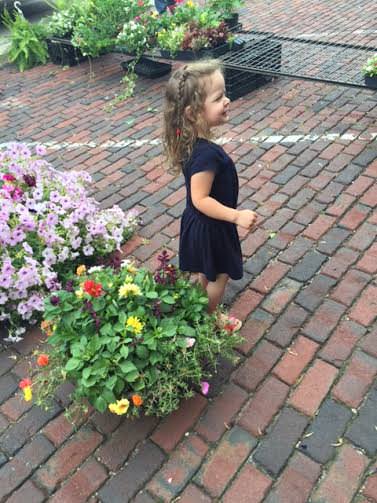 My daughter, Aster, stops and smells the flowers