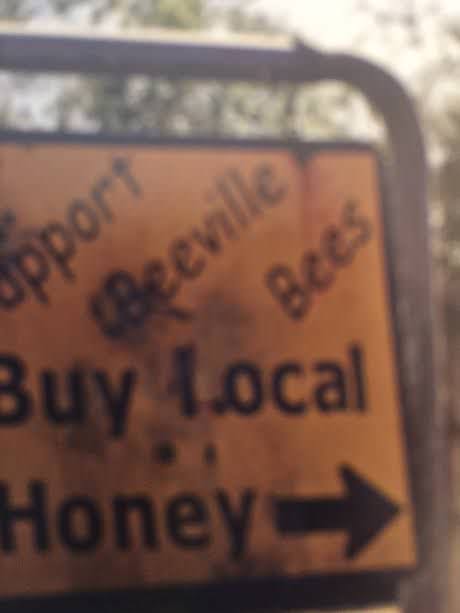 A sign points the way to homemade honey at an Amish farm outside Beeville
